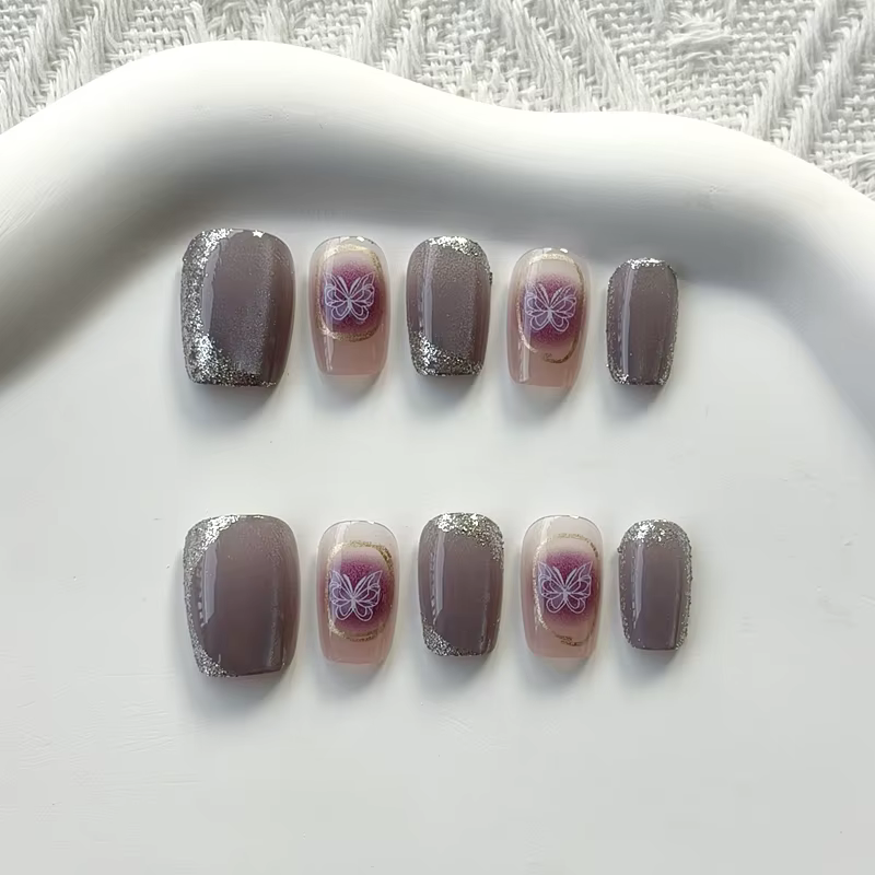 Femmes à la main papillon violet avec diamants conceptions scintillant oeil de chat presse sur les ongles pièce d'ongle